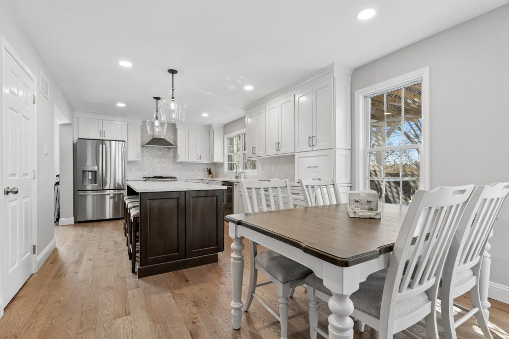 Open concept kitchen and dining area with Mirage Red Oak hardwood floors in Royersford PA renovation by Majestic Home Renovations